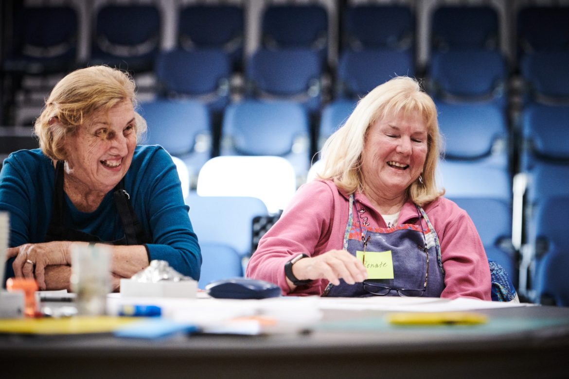 Two women laughing at a workshop