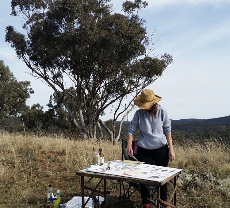 Patrice Wills working on an artwork outside