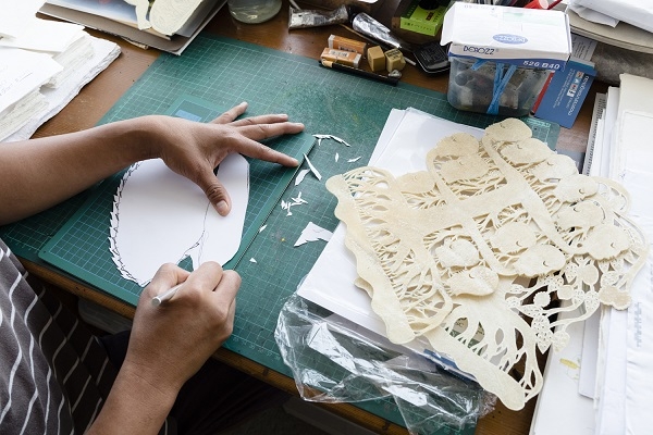Close up of Jumaadi working on his shadow puppets in his studio
