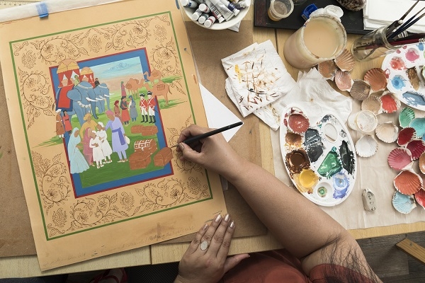 Close up image of Fozia Zahid working on a miniature painting
